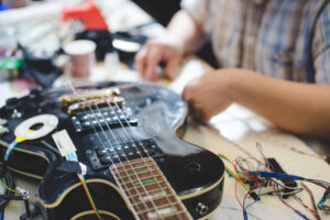 Electric guitar being augmented with sensors